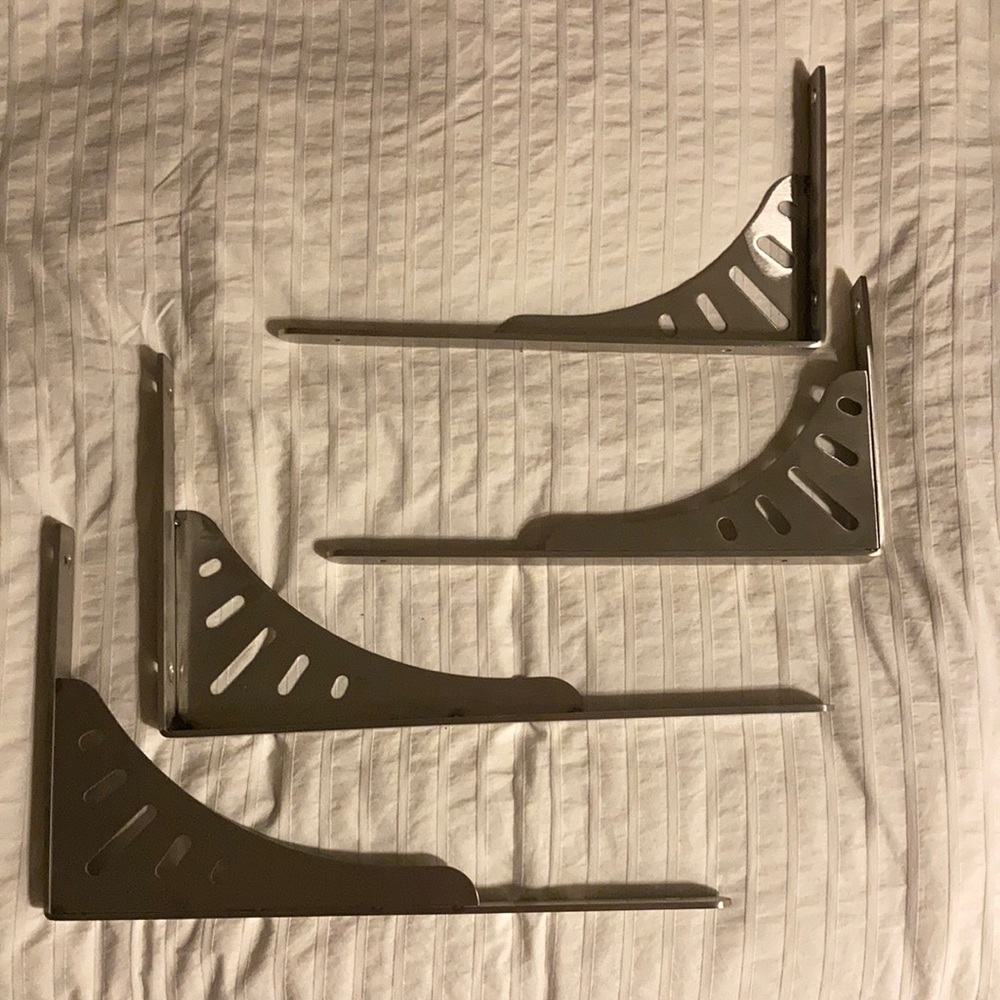 2 sets of shelf brackets, both silver. One set is 14 inches long, the other 12.